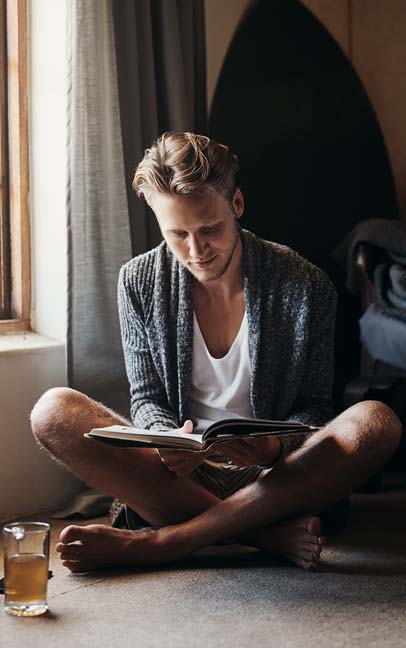 Man enjoying reading with a cup of coffee